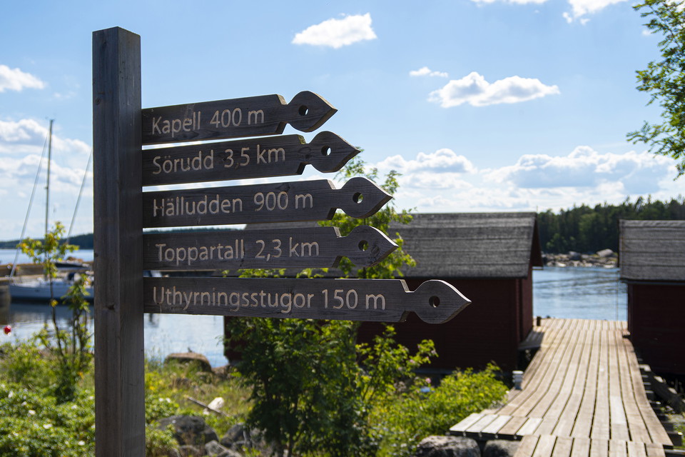 Flera träskyltar som visar vägen ute på Storjungfrun