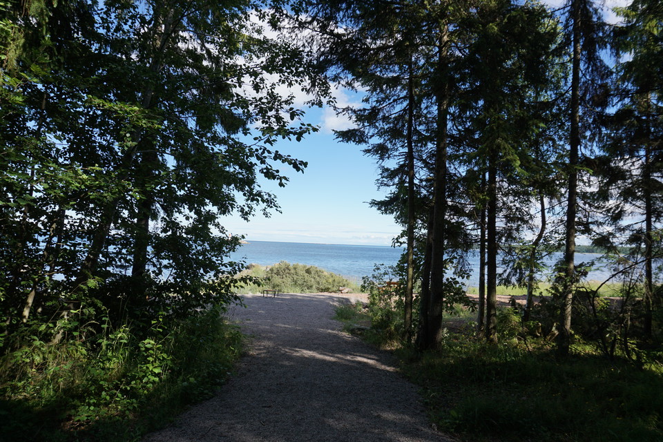 Grusväg mot rastplats med utsikt över havet