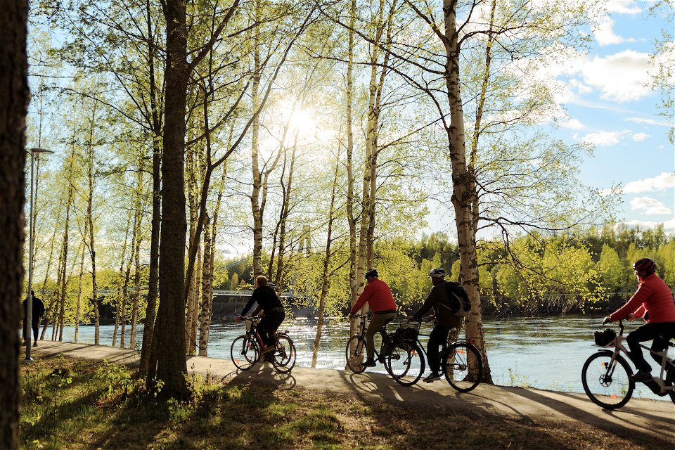 Cyclists by the river.