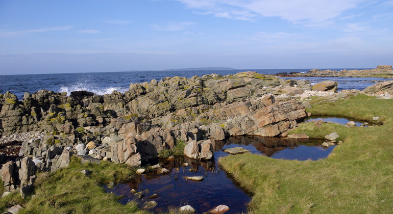 Stenig och blockig strand.