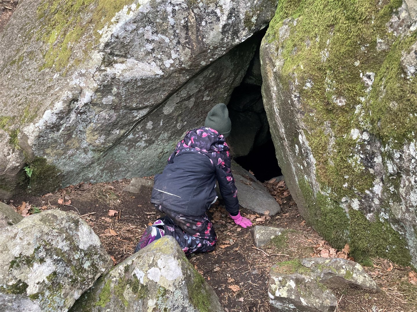 En flicka kikar in i grottan