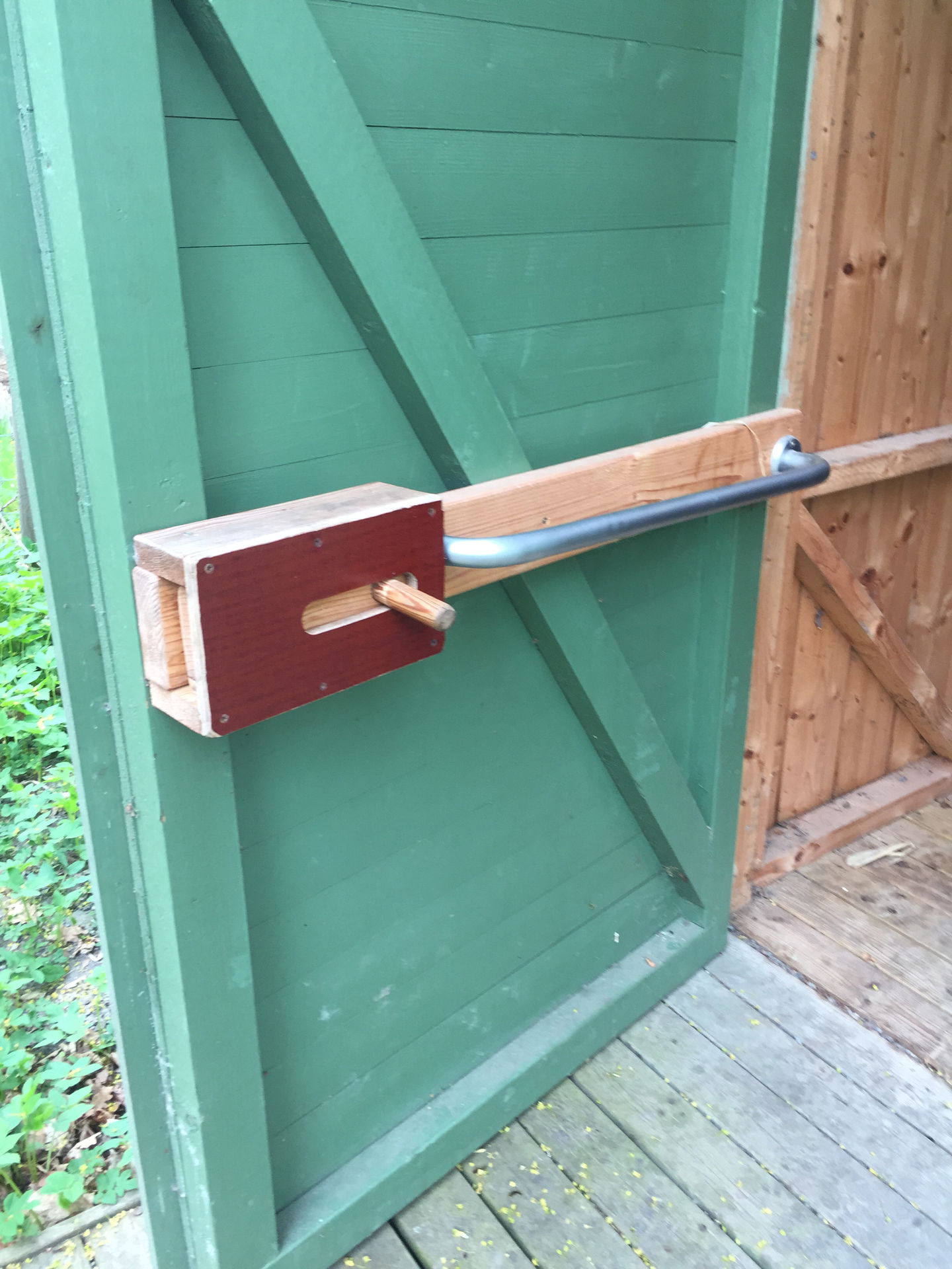 Närbild på insidan av tillgänglighetsanpassade toaletten. Dörren har ett stort handtag och ett skjutlås.