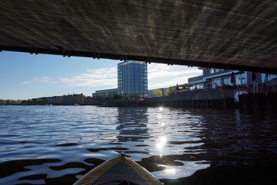 Paddling under bro i Gavleån med utsikt mot höghus