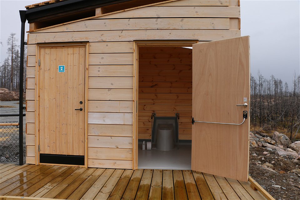 Byggnad med två toaletter. Dörren är öppen int till handikapptoaletten.