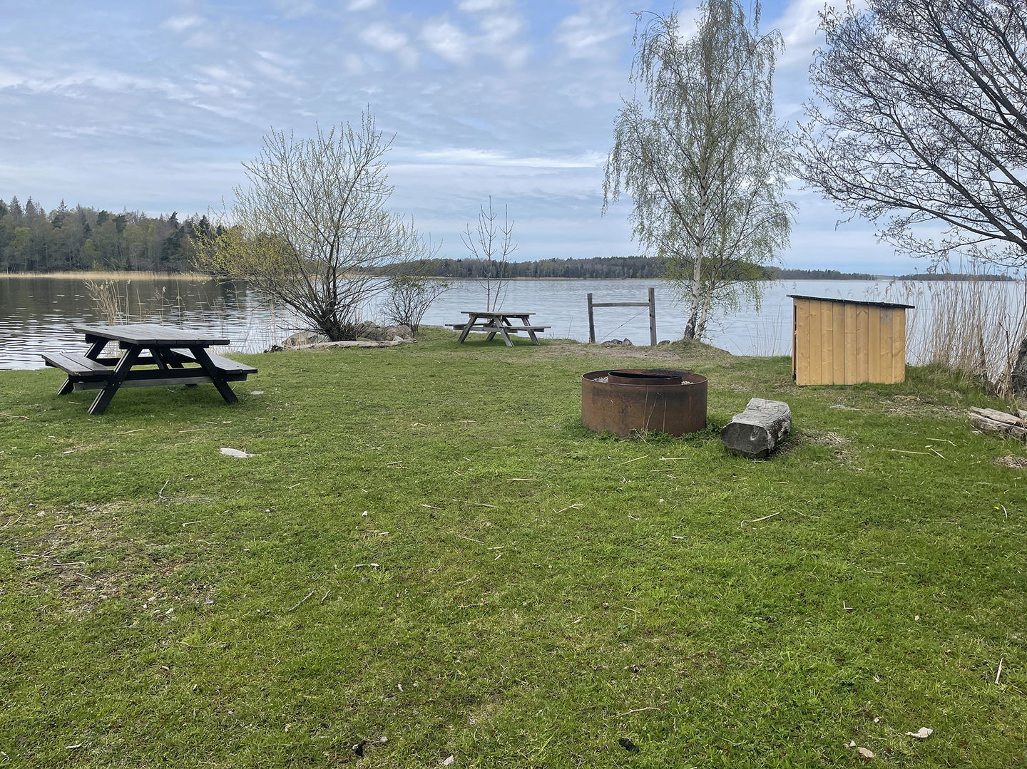 Picknickbord, grillstad och vedförråd.