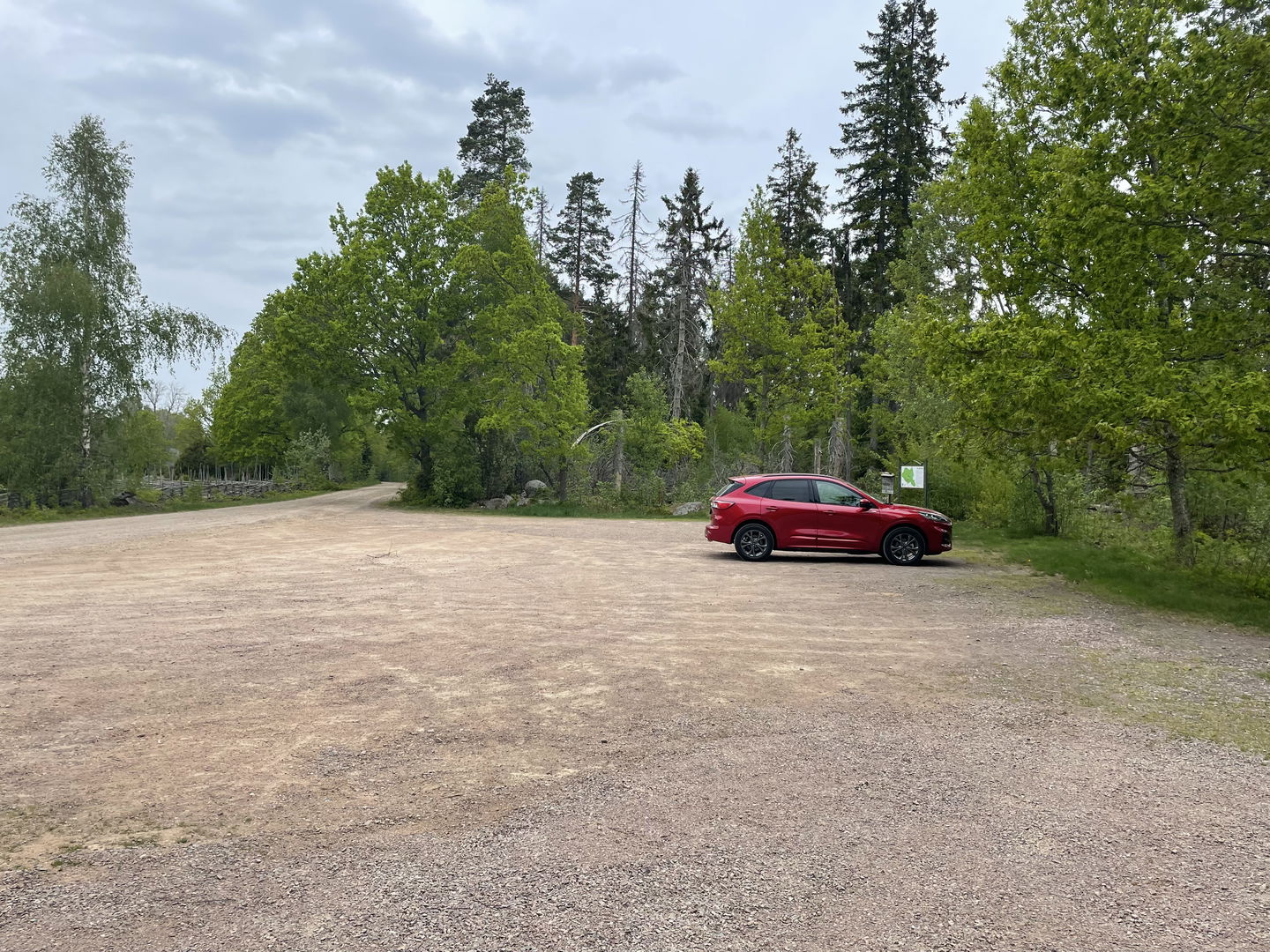 Parkeringsplats med röd bil