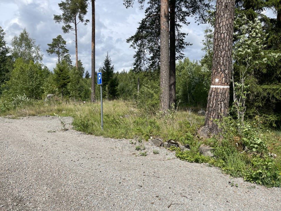 Parkeringsskylt och naturreservatsmarkering.