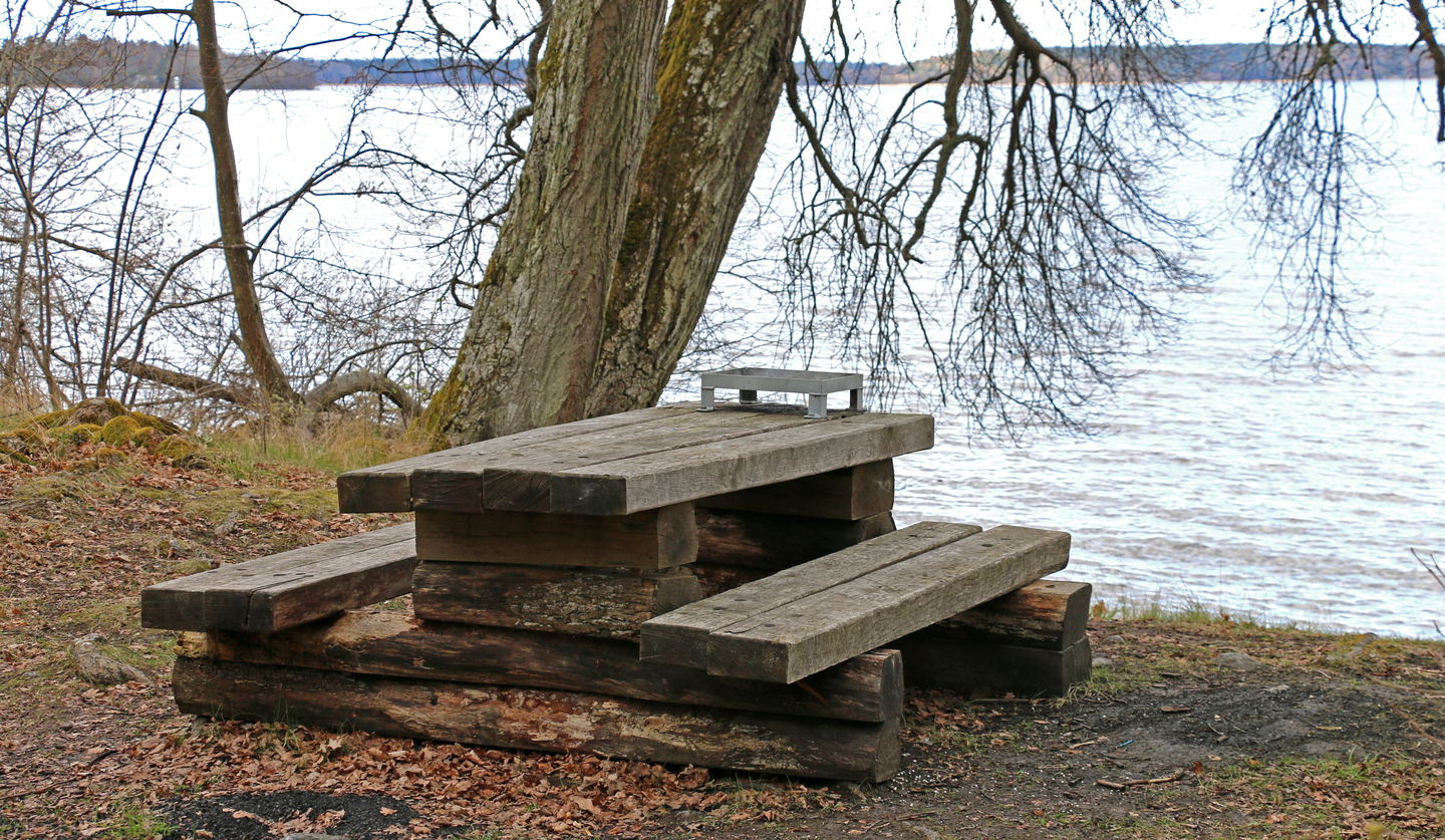 Bord med bänkar intill Mälaren.
