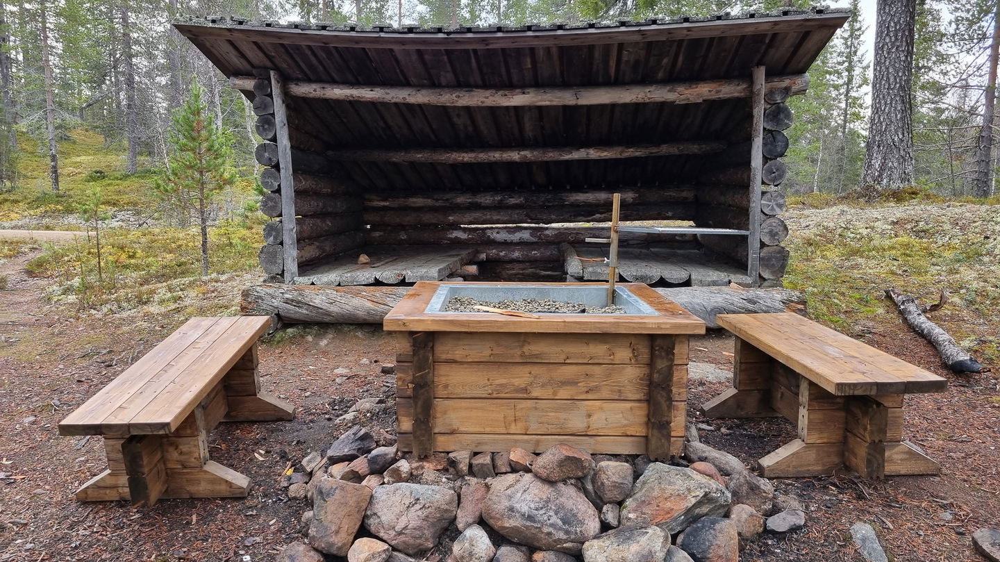 A photo of a fireplace with wooden benches.