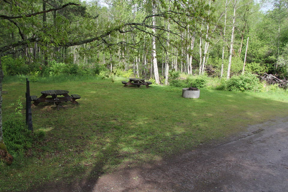 Rastplats med eldstad, två bord och bänkar.