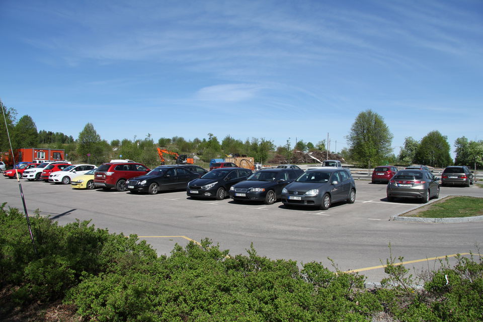 Parkerade bilar på en stor parkering.