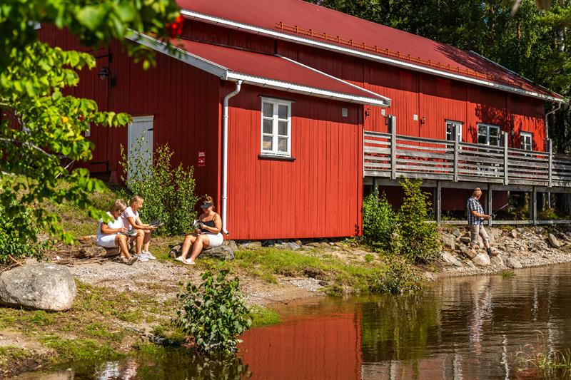 En av bygningene på Sandstangen med folk utenfor som koser seg.