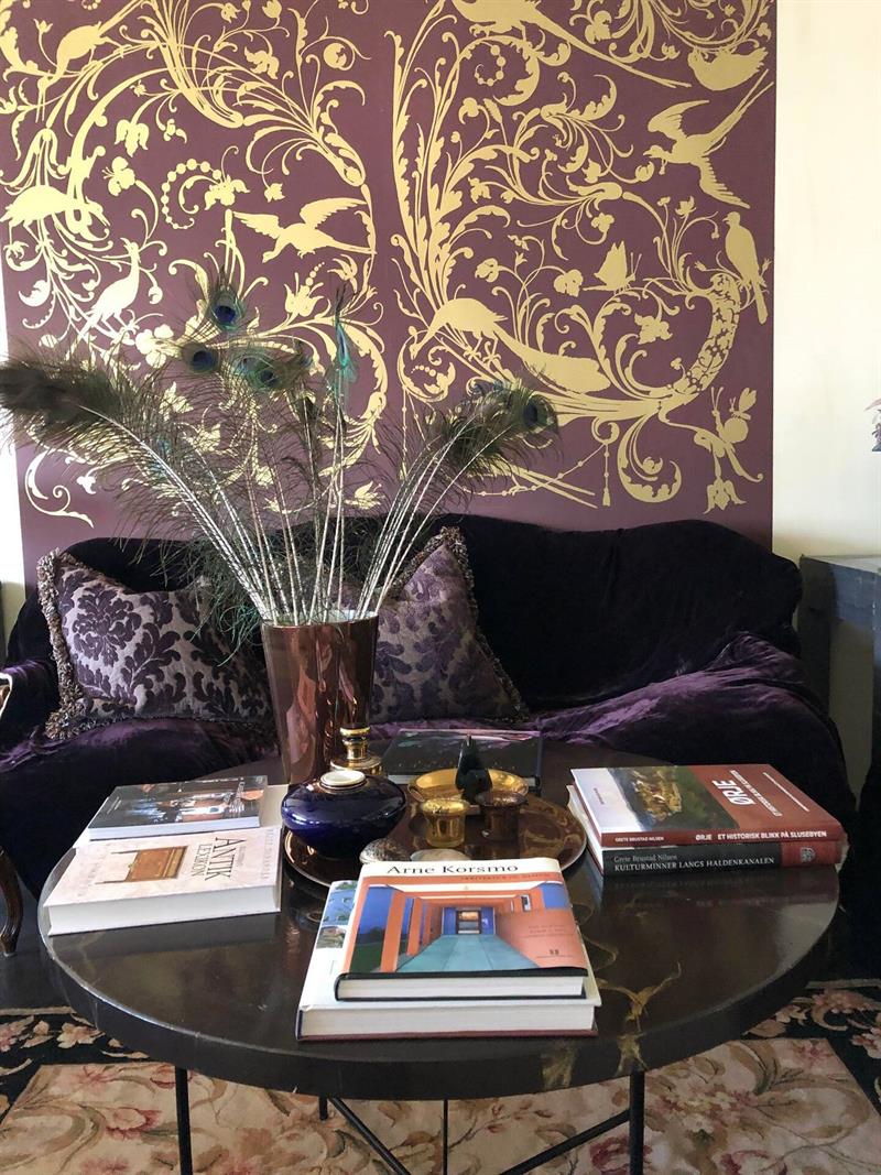 The purple sofa in the living room with matching wall