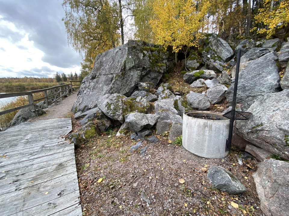 En liten grillplats i form av ett cementrör står intill en klippvägg.
