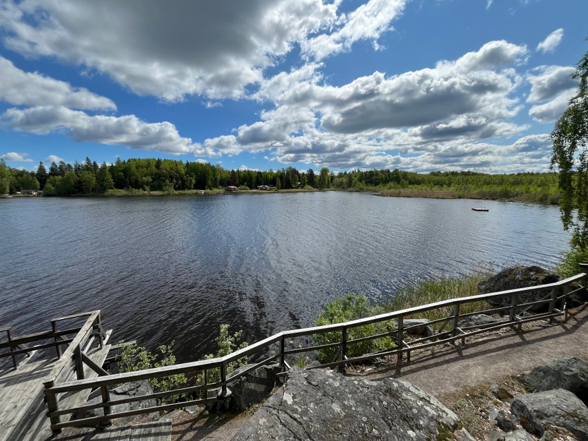 Utsikt från en höjd över gångväg som går längs med en sjö.